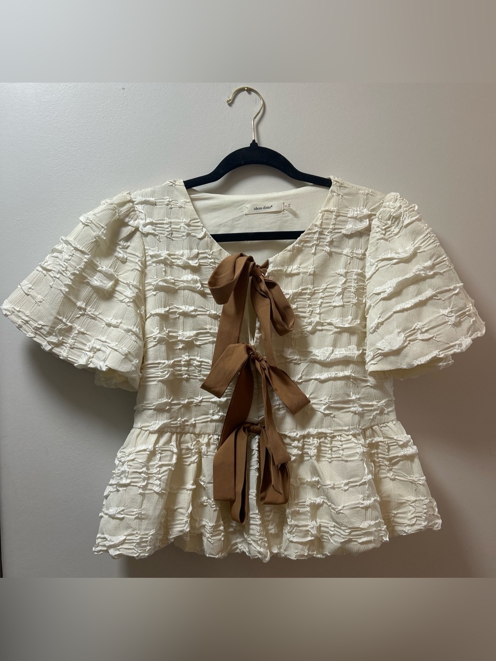 cream textured peplum blouse with brown bow ties
